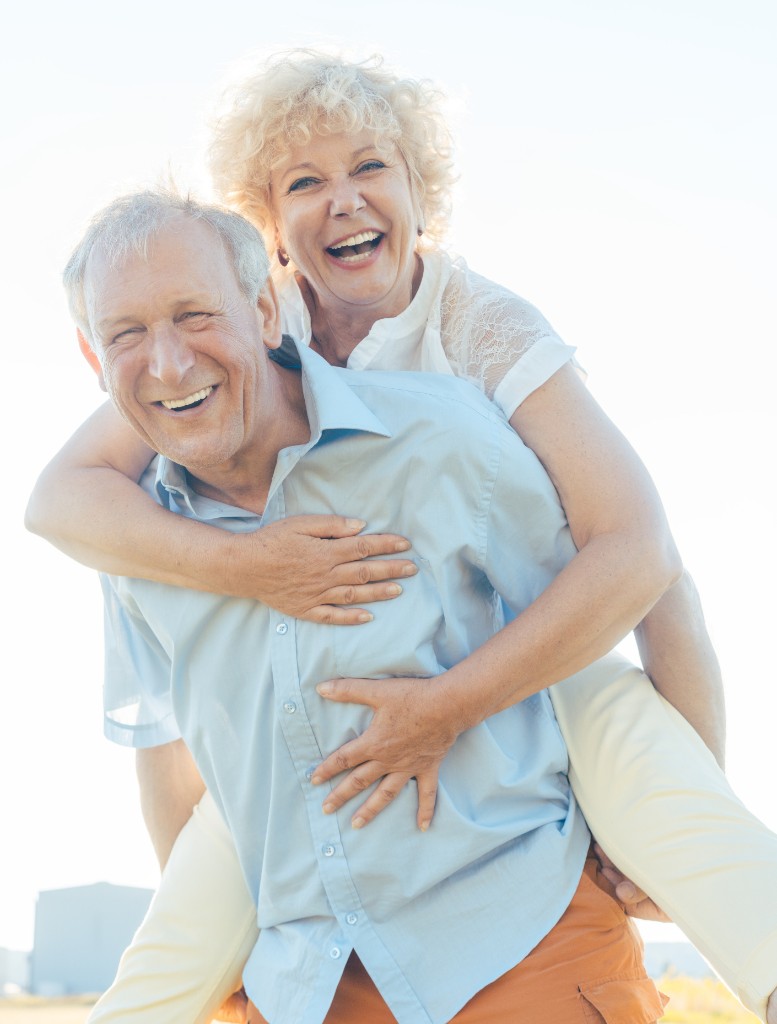 Happy older couple outdoors, laughing together
