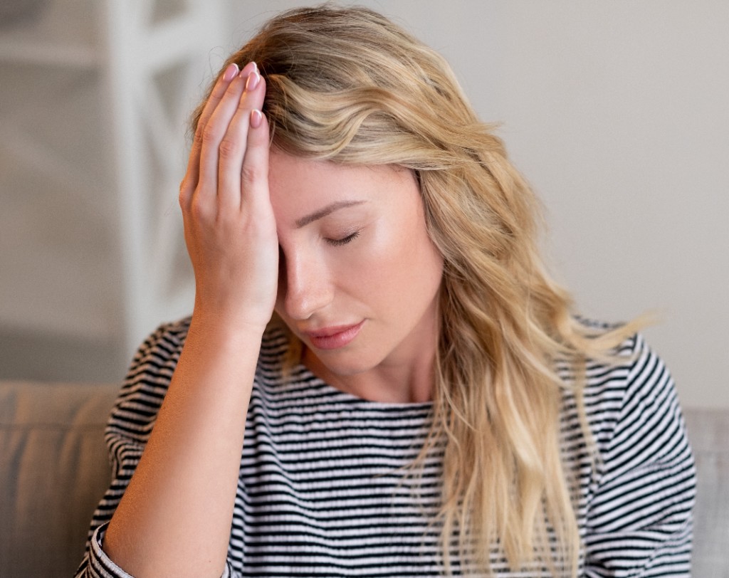 Woman experiencing stress or fatigue related to sleep disturbance
